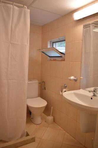 a bathroom with a toilet and a sink at Villas Holidays in Primorsko