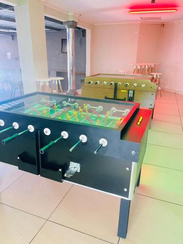 a ping pong table in a room with a tableablishangering at Boeketlong Lodge in Jane Furse
