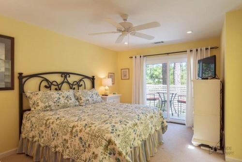a bedroom with a bed and a ceiling fan at 12 Isle of Pines in Hilton Head Island