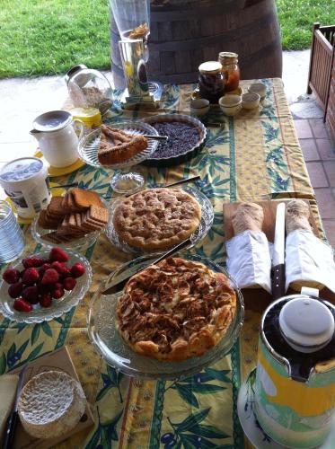 a table with pies and other food on it at Cascina La Maddalena Bed & Wine in Rocca Grimalda