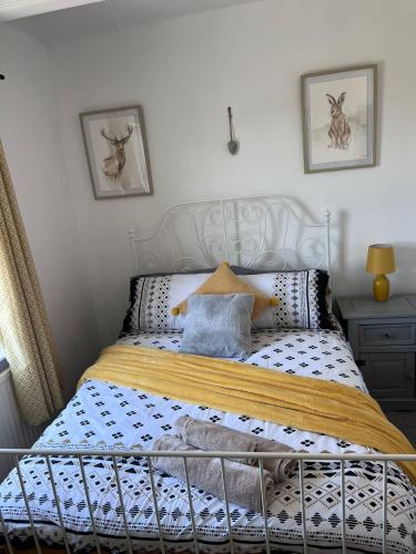 a bedroom with a bed with a white headboard at Family & friends get together birthday hot tub in Porthcawl