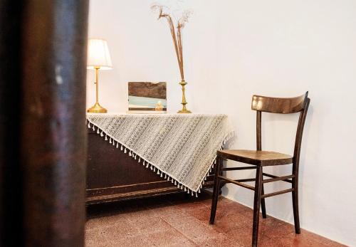 a table with a chair and a table cloth on it at Archita51 in Bernalda