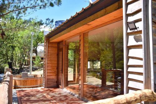 a house with sliding glass doors on a patio at Domos Altos de Lircay in San Clemente