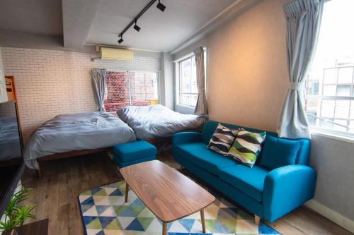 a room with a bed and a couch and a table at Chatelet Yoyogi - Vacation STAY 15465 in Tokyo