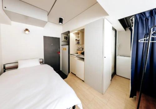 a small bedroom with a bed and a kitchen at ＰＩＡＺＺＡーＵ - Vacation STAY 78015v in Tokyo