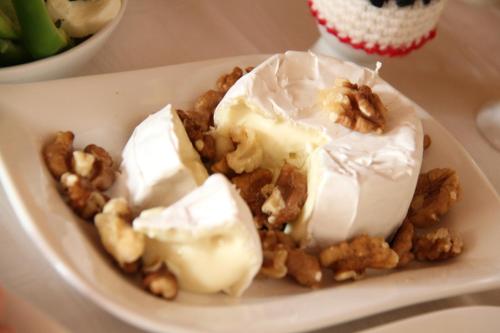 a plate of food with ice cream and nuts at Gästehaus Lokalaugenschein in Podersdorf am See