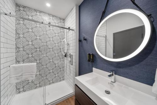 a bathroom with a sink and a mirror at Cannery Lofts Niagara in Niagara Falls