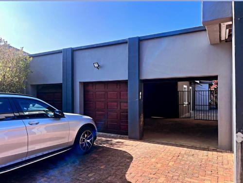 a car parked in front of a garage at La Creme Ilanga Waterkloof in Pretoria