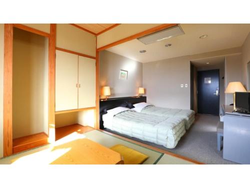 a bedroom with a bed and a tv in it at Hotel Silk in Madarao - Vacation STAY 79648v in Iiyama