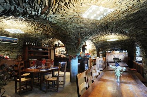 ein Esszimmer mit einem Tisch und Stühlen in einem Gebäude in der Unterkunft Stadel Soussun in Champoluc