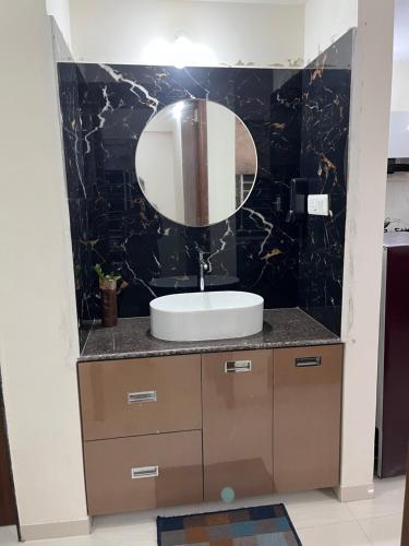 a bathroom with a sink and a mirror at Little nest Homestay in Pune