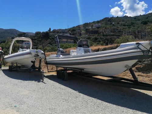 a small boat is parked on a trailer at "Appartamento del Mare Gliaca" con vista Isole Eolie,ampia terrazza,wifi e parcheggio gratuito in Piraino