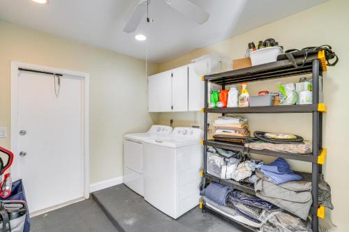 a laundry room with a washer and dryer on a shelf at Fort Myers Vacation Home with Patio about 14 Mi to Beach in Fort Myers