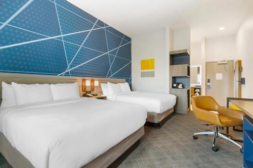 a hotel room with two beds and a desk at Comfort Inn & Suites Houma in Houma