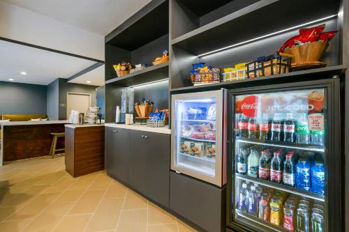 a restaurant with an open refrigerator with drinks at Comfort Inn & Suites Houma in Houma