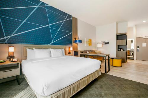 a hotel room with a large bed and a desk at Comfort Inn & Suites Houma in Houma