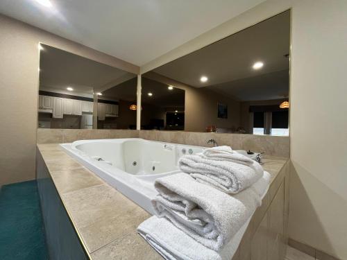 a bathroom with a bath tub with towels on it at Western Budget Motel #1 & 2 Whitecourt in Whitecourt