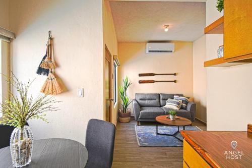 a living room with a couch and a table at NEW Comfy Stay with Pool Onsite Steps from Malecón in La Paz