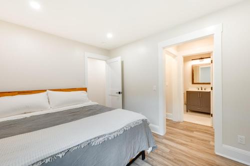 une chambre blanche avec un lit et une salle de bain dans l'établissement Mid-Century Tenney Mountain Condo Near Hiking, à Plymouth
