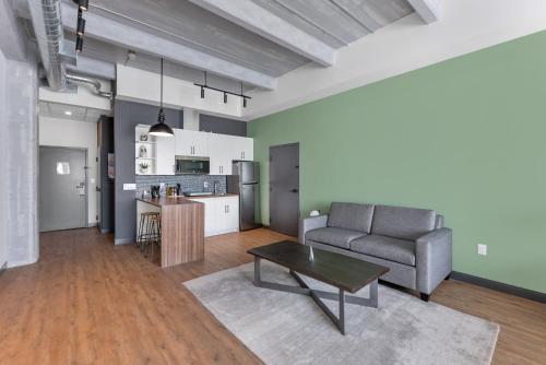 a living room with a couch and a table at Cannery Lofts Niagara in Niagara Falls