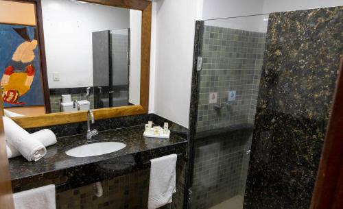 a bathroom with a sink and a shower at Hotel Village Porto De Galinhas in Porto De Galinhas