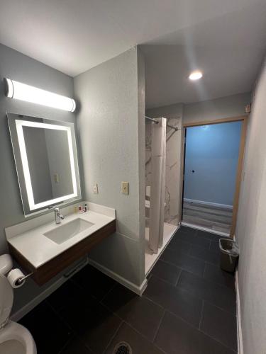 a bathroom with a sink and a shower at Microtel Inn by Wyndham Atlanta Airport in Atlanta