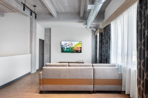 a row of chairs in a room with a window at Cannery Lofts Niagara in Niagara Falls