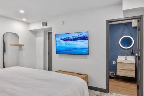a bedroom with a bed and a sink at Cannery Lofts Niagara in Niagara Falls