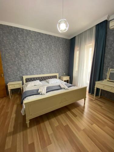 a bedroom with a large bed in a room at City Center Apartment in Kutaisi