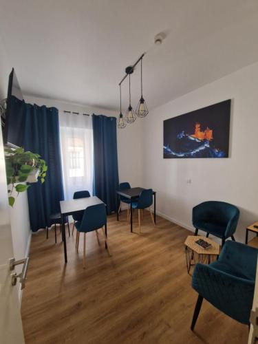 a living room with blue chairs and a table at Casa do Albuquerque II in Sintra