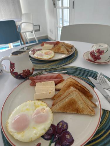 a plate of breakfast food with eggs and toast at Placita Vieja Hotel Boutique Spa in Santa Marta
