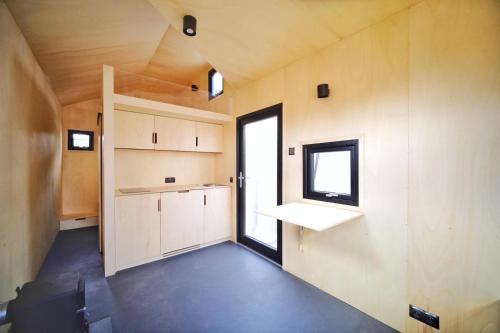 a small kitchen in a small house with a window at Modern Tiny House 
