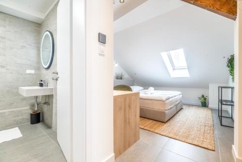 a bathroom with a sink and a bed in a room at Apartman Kaptol in Zagreb