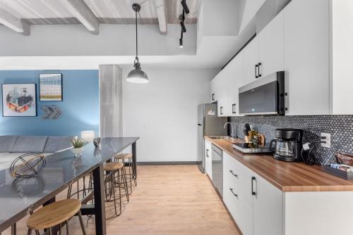 a kitchen with white cabinets and a counter top at Cannery Lofts Niagara in Niagara Falls