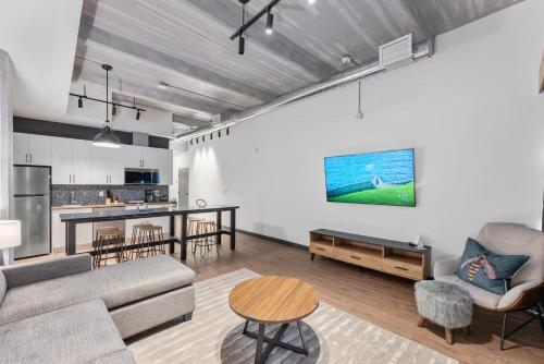 a living room with a couch and a table at Cannery Lofts Niagara in Niagara Falls