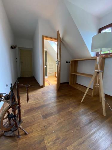 an attic room with a ladder and a room with a staircase at Landdomizil Zeißig in Hoyerswerda