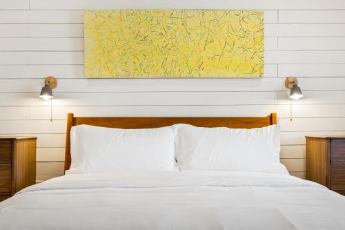 a bedroom with a white bed with two lights above it at Boutique Room steps from Downtown Mall Rose Jean Room 1 in Charlottesville