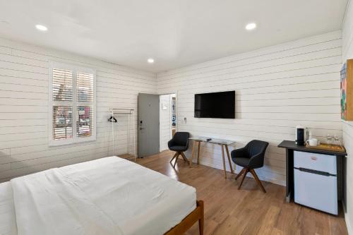 a bedroom with a bed and a desk and a tv at Boutique Room steps from Downtown Mall Rose Jean Room 1 in Charlottesville
