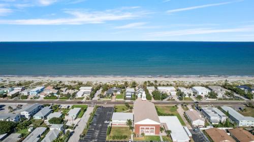 an aerial view of a resort with the beach at Oceanfront Cocoa Beach Vacation Home Private Beach, Tiki Bar & Family Fun in Cocoa Beach