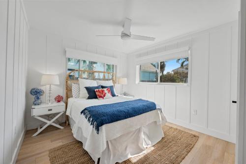 a white bedroom with a bed and a window at Vista Del Mar Oceanfront Home Stunning Views Backyard Oasis in Cocoa Beach