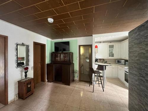 a kitchen with a table and chairs in a room at Haus Elli 