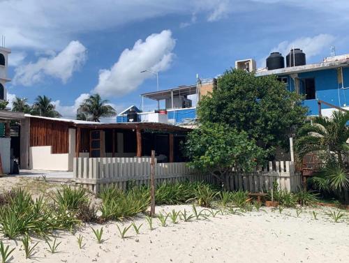 a house on the beach with a fence at Casa Lucia Beachfront Puerto Morelos in Puerto Morelos