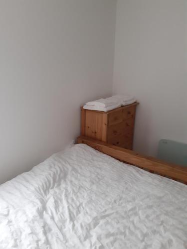 a small bedroom with a bed and a dresser at Heart of Deptford in London