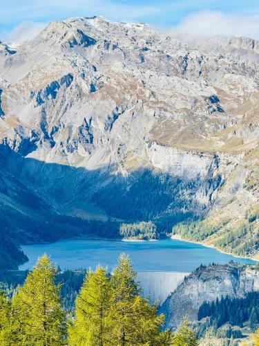 a view of a lake in front of a mountain at L'AvantGardiste, Spacious 6 bedrooms duplex, panoramic view in Crans-Montana
