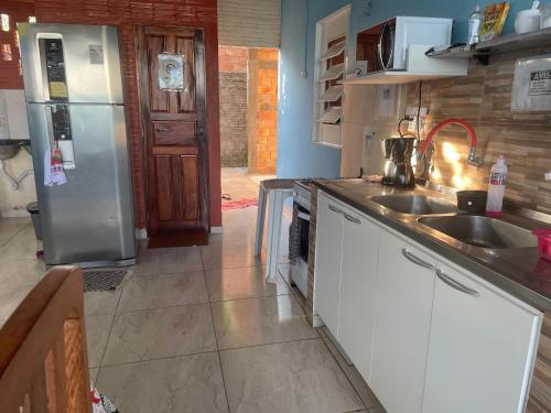 cocina con fregadero y nevera en Hostel Carol, en Boa Vista