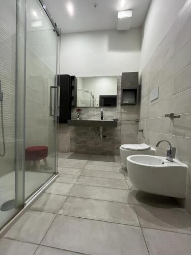 a bathroom with a sink and a toilet and a shower at La Piazzetta Anzio in Anzio