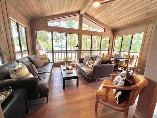 a living room with leather couches and a table at Hammock Trail Lake - Lake Park - Valdosta Area in Lake Park