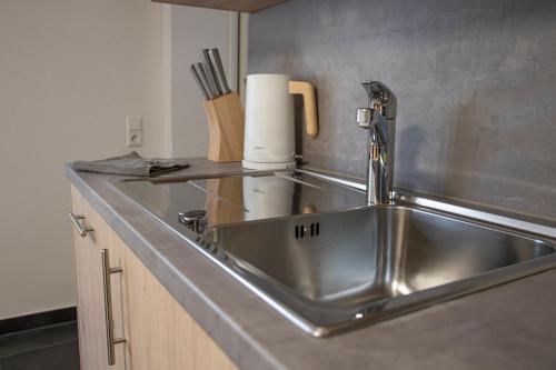 a stainless steel sink in a kitchen with a counter at Ferienwohnung Bauernhaus in Balingen