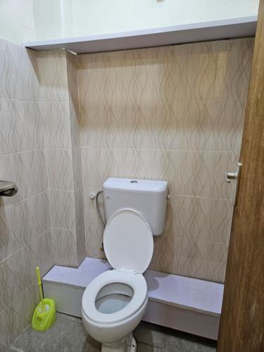 a bathroom with a white toilet in a room at Airport Studio Apartments-JKIA in Nairobi