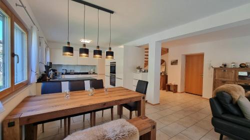a kitchen and dining room with a wooden table at Chalet Michelangelo in Zermatt